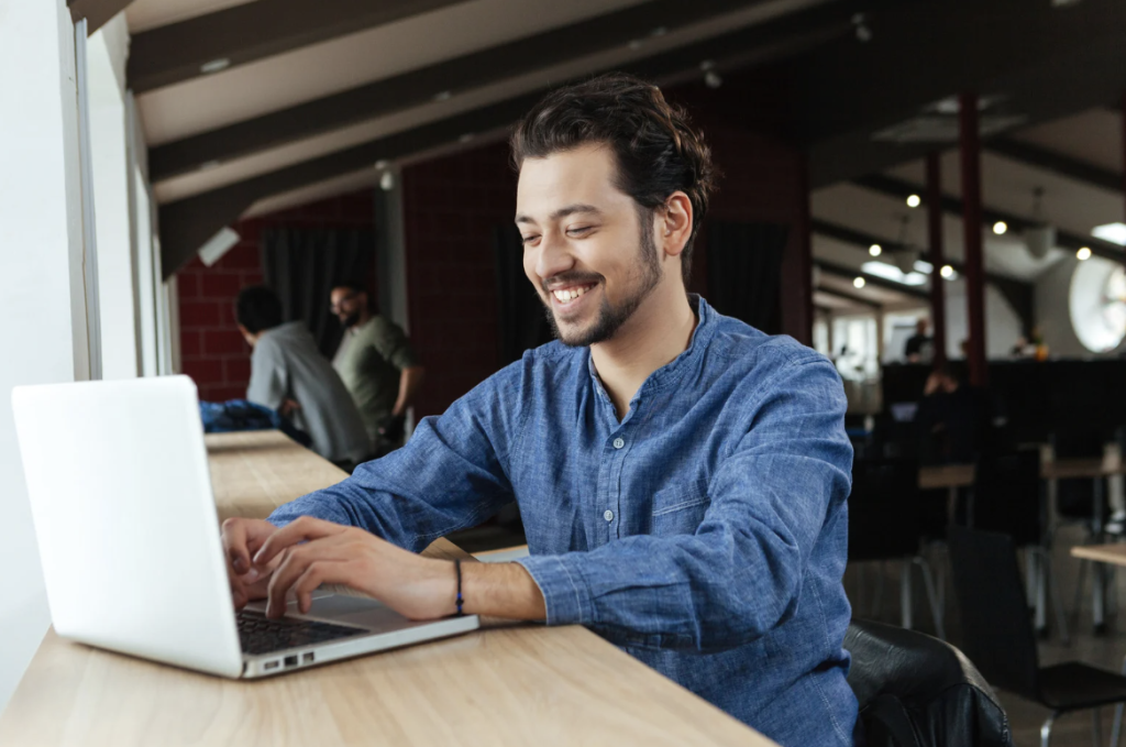 man searching powersports on his laptop